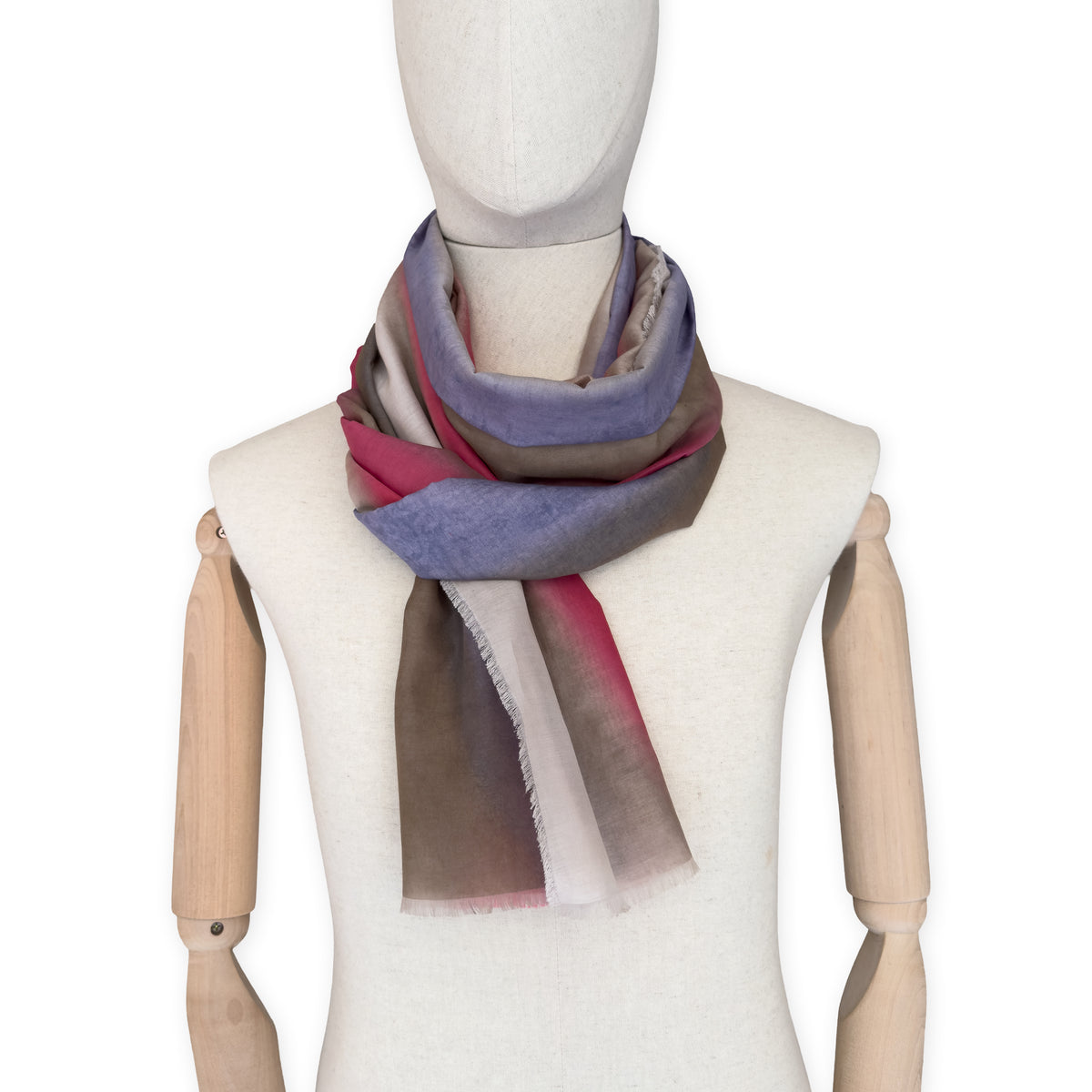 Mannequin wearing a hand-painted Otta silk cotton blend scarf on a white background in 
brown, beige, red and purple tones. soft, fresh and lightweight, and elegant accessory measuring 70 x 190 cm. Unique artisan scarf with hand-fringed edges, perfect for women and men.
