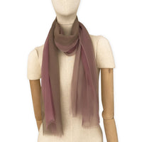 Mannequin wearing an elegant hand-painted Otta pure silk organza scarf on a gray background. Pink, beige and brown tones.
