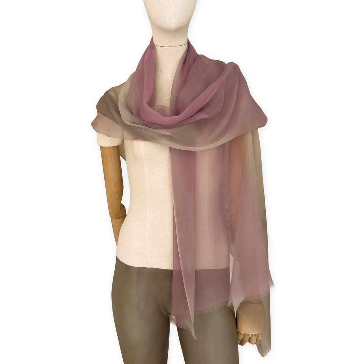 Mannequin wearing an elegant hand-painted Otta pure silk organza scarf on a gray background. Pink, beige and brown tones.
