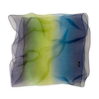Hand-painted pure silk organza scarf by Otta-Italy flat lay on a white background. Blue, green and violet luxury accessory. With delicate hand-fringed edges.
