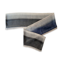 Gradient scarf on a white background. Hand-painted pure silk scarf by Otta-Italy, 24 x 168 cm, featuring gray and midnight blue. Luxury Italian silk accessory, soft and lightweight scarf for women and men.
