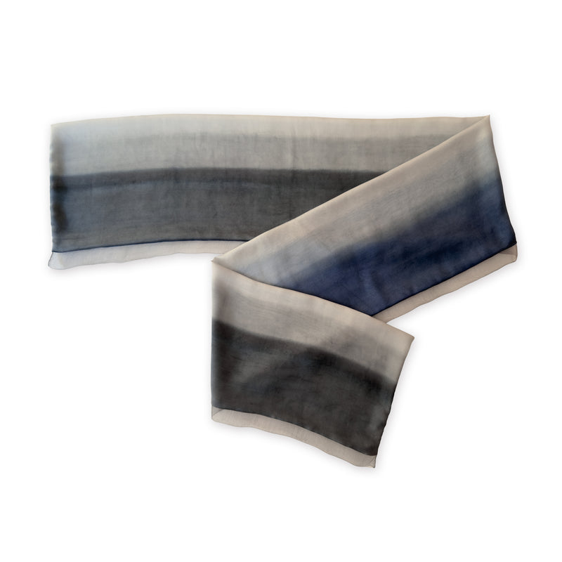 Gradient scarf on a white background. Hand-painted pure silk scarf by Otta-Italy, 24 x 168 cm, featuring gray and midnight blue. Luxury Italian silk accessory, soft and lightweight scarf for women and men.
