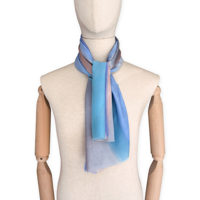 Mannequin wearing a pastel gradient scarf on a white background. Silk-scarf-hand-painted-45x180cm-blue-gray-turquoise-otta-italy