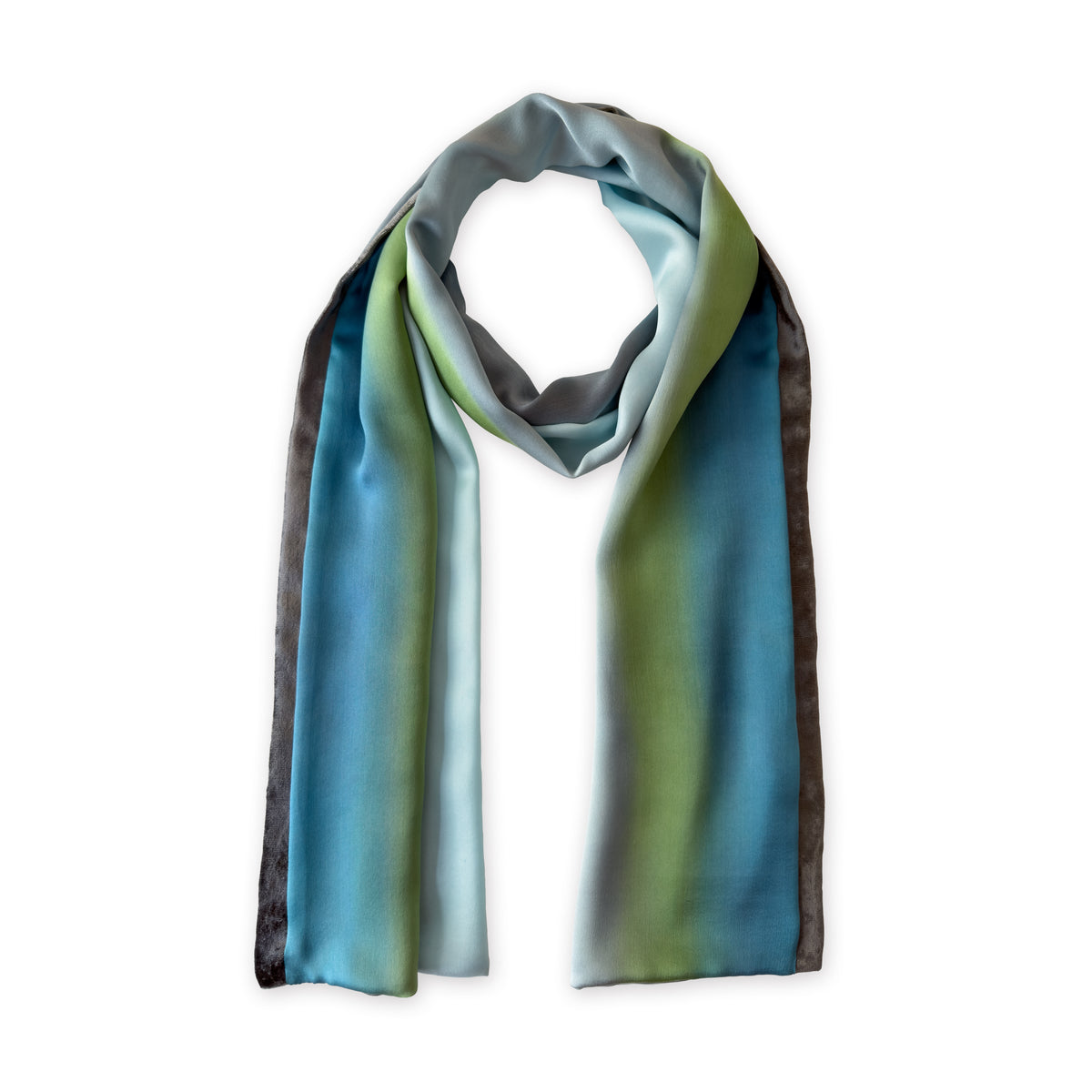 Colorful silk scarf in gray, light blue, turquoise and green shades on a white background. t is hand-painted scarf in measures 172 x 22 cm by otta-italy scarves brand. Luxury Italian silk accessory, soft and lightweight scarf for women and men.
