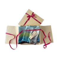 Set of scarves in a gift box with a pink ribbon on a white background. 
Hand-painted silk scarf by Otta-Italy, 172 x 22 cm, featuring gray, light blue, turquoise and green colors. Luxury Italian silk scarf, soft and lightweight scarf for women and men.
