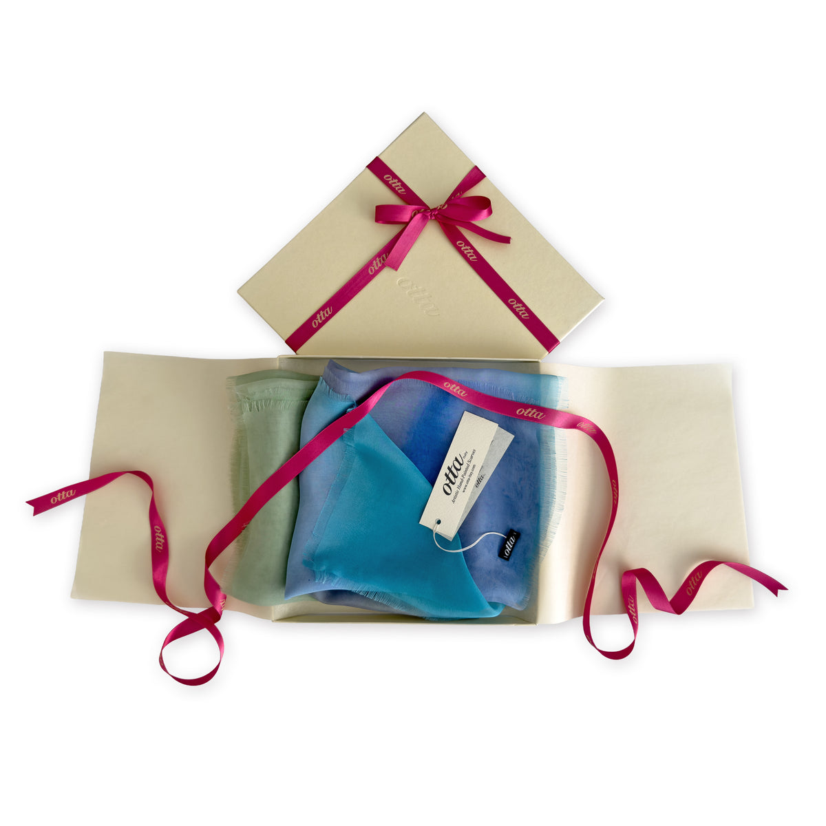 Set of scarves in a gift box with a pink ribbon on a white background. 
Hand-painted silk scarf by Otta-Italy, 65 x 175 cm, featuring 
blue, green and gray shades. Luxury Italian pure silk accessory, soft, fresh and lightweight scarf for women and men.
