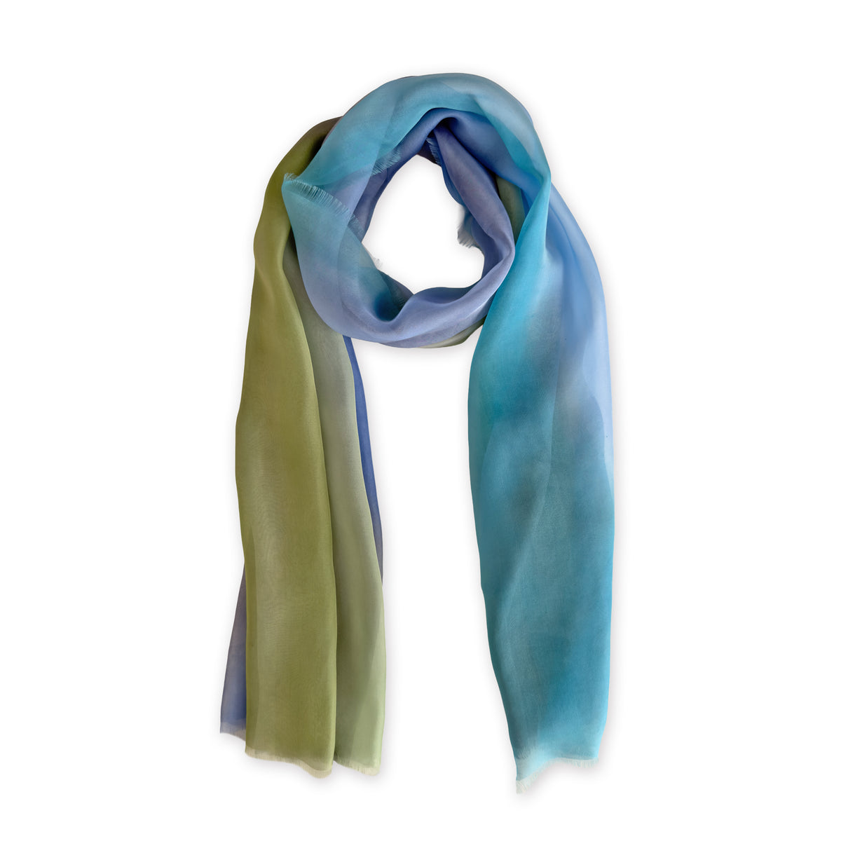 A hand-painted Otta pure silk scarf on a white background, in 
blue, green and gray shades, loosely looped to showcase its full length and delicate texture. Lightweight artisan accessory with hand-fringed edges, measuring 65 x 175 cm.
