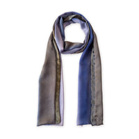 Colorful silk scarf in blue, lilac and brown shades on a white background. t is hand-painted scarf in measures 171 x 24 cm by otta-italy scarves brand. Luxury Italian silk accessory, soft and lightweight scarf for women and men.
