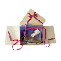 Set of scarves in a gift box with a pink ribbon on a white background. 
Hand-painted silk scarf by Otta-Italy, 171 x 24 cm, featuring blue, lilac and brown colors. Luxury Italian silk scarf, soft and lightweight scarf for women and men.
