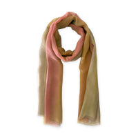 A hand-painted Otta pure silk scarf on a white background, in 
pink, yellow and brown shades, loosely looped to showcase its full length and delicate texture. Lightweight artisan accessory with hand-fringed edges, measuring 65 x 175 cm.
