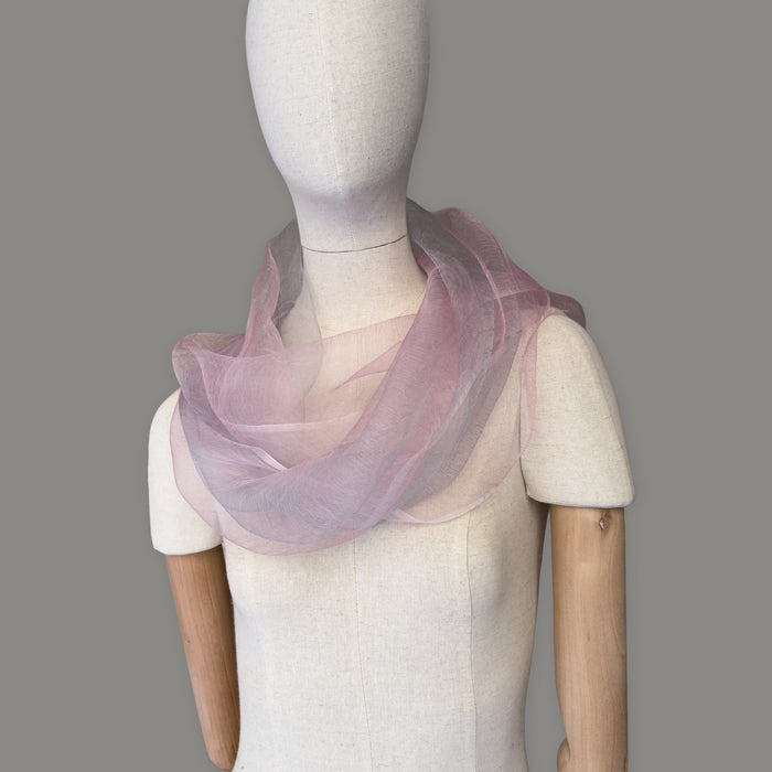 Mannequin wearing scarf on a gray background. Hand-painted silk scarf by Otta-Italy, 50 x 200 cm, featuring 
pink and light gray. Luxury Italian pure silk accessory, soft and lightweight scarf for women and men.
