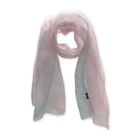 Hand-painted Otta silk scarf in 
pink and light gray, loosely looped to showcase its full length and delicate texture in white background. Lightweight artisan accessory with hand-fringed edges, measuring 50 x 200 cm.

