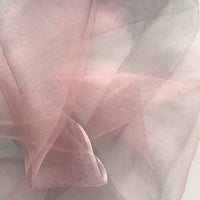 Close-up of a hand-painted Otta silk scarf draped softly, showcasing gentle shades of 
pink and light gray. Lightweight artisan accessory with delicate hand-fringed edges, measuring 50 x 200 cm.


