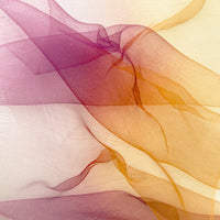 Close-up of a hand-painted Otta pure silk organza scarf showcasing vibrant shades of orange, red and pink.
