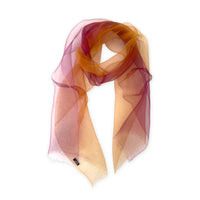 Loosely looped hand-painted Otta pure silk organza scarf on a white background, showcasing its sheer texture and length. 48x185 cm. With delicate hand-fringed edges.
