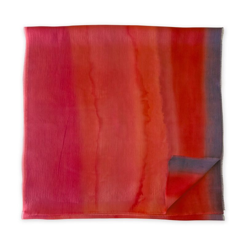 Folded fabric with red and orange gradient on a white background - Hand-Painted scarf. Otta-italy