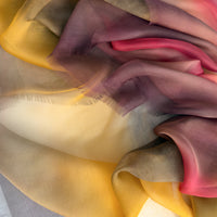 Close-up of fabric. Hand-painted silk scarf by Otta-Italy, 176 x 64 cm, featuring red, orange, yellow and brown colors. Luxury Italian silk scarf, soft and lightweight scarf for women and men.

