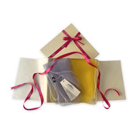 Set of scarves in a gift box with a pink ribbon on a white background. 
Hand-painted silk scarf by Otta-Italy, 50 x 194 cm, featuring yellow and gray colors. Luxury Italian silk scarf, soft and lightweight scarf for women and men.
