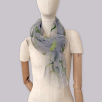 Mannequin wearing a hand-painted silk organza and wool felt scarf by Otta-Italy, gray background. Gray and green wearable art. 183x44 cm.