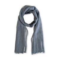 A hand-painted Otta pure silk with hand-needle felted wool scarf on a white background, in 
gray shades, loosely looped to showcase its full length and delicate texture. Lightweight artisan accessory with hand-fringed edges, measuring 40 x 176 cm.
