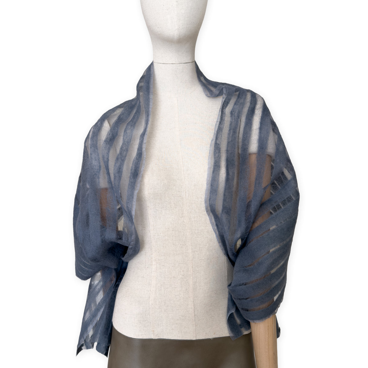 Mannequin wearing a hand-painted Otta pure silk with hand-needle felted wool scarf on a white background in 
gray tones. soft, fresh and lightweight, and elegant accessory measuring 40 x 176 cm. Unique artisan scarf with hand-fringed edges, perfect for women and men.
