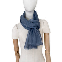 Mannequin wearing a hand-painted Otta pure silk with hand-needle felted wool scarf on a white background in 
gray tones. soft, fresh and lightweight, and elegant accessory measuring 40 x 176 cm. Unique artisan scarf with hand-fringed edges, perfect for women and men.
