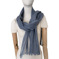 Mannequin wearing a hand-painted Otta pure silk with hand-needle felted wool scarf on a white background in 
gray tones. soft, fresh and lightweight, and elegant accessory measuring 40 x 176 cm. Unique artisan scarf with hand-fringed edges, perfect for women and men.
