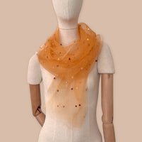 Mannequin wearing scarf on a beige background. Hand-painted silk scarf with hand-needle felted wool by Otta-Italy, 183 x 44 cm, featuring 
orange, peach, beige and brown. Luxury Italian pure silk accessory, soft, fresh and lightweight scarf for women and men.
