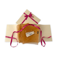 Set of scarves in a gift box with a pink ribbon on a white background. 
Hand-painted silk with hand-needle felted wool scarf by Otta-Italy, 183 x 44 cm, featuring 
orange, peach, beige and brown shades. Luxury Italian pure silk accessory, soft, fresh and lightweight scarf for women and men.
