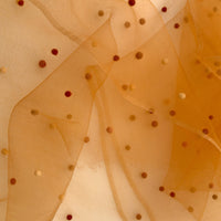 Close-up of a hand-painted Otta pure silk scarf draped softly with hand-needle felted wool showcasing gentle shades of 
orange, peach, beige and brown. Lightweight artisan accessory with delicate hand-fringed edges, measuring 183 x 44 cm.
