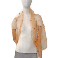 Mannequin wearing a hand-painted Otta pure silk with hand-needle felted wool scarf on a white background in 
orange, peach, beige and brown tones. soft, fresh and lightweight, and elegant accessory measuring 183 x 44 cm. Unique artisan scarf with hand-fringed edges, perfect for women and men.
