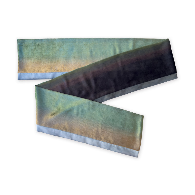Colorful velvet scarf in green, beige and blue navy shades on a white background. t is hand-painted scarf in measures 182 x 18 cm by otta-italy scarves brand. Luxury Italian velvet accessory, soft and warm scarf for women and men.
