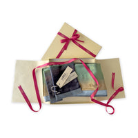 Set of scarves in a gift box with a pink ribbon on a white background. 
Hand-painted velvet scarf by Otta-Italy, 182 x 18 cm, featuring green, beige and blue navy colors. Luxury Italian velvet scarf, soft and warm scarf for women and men.

