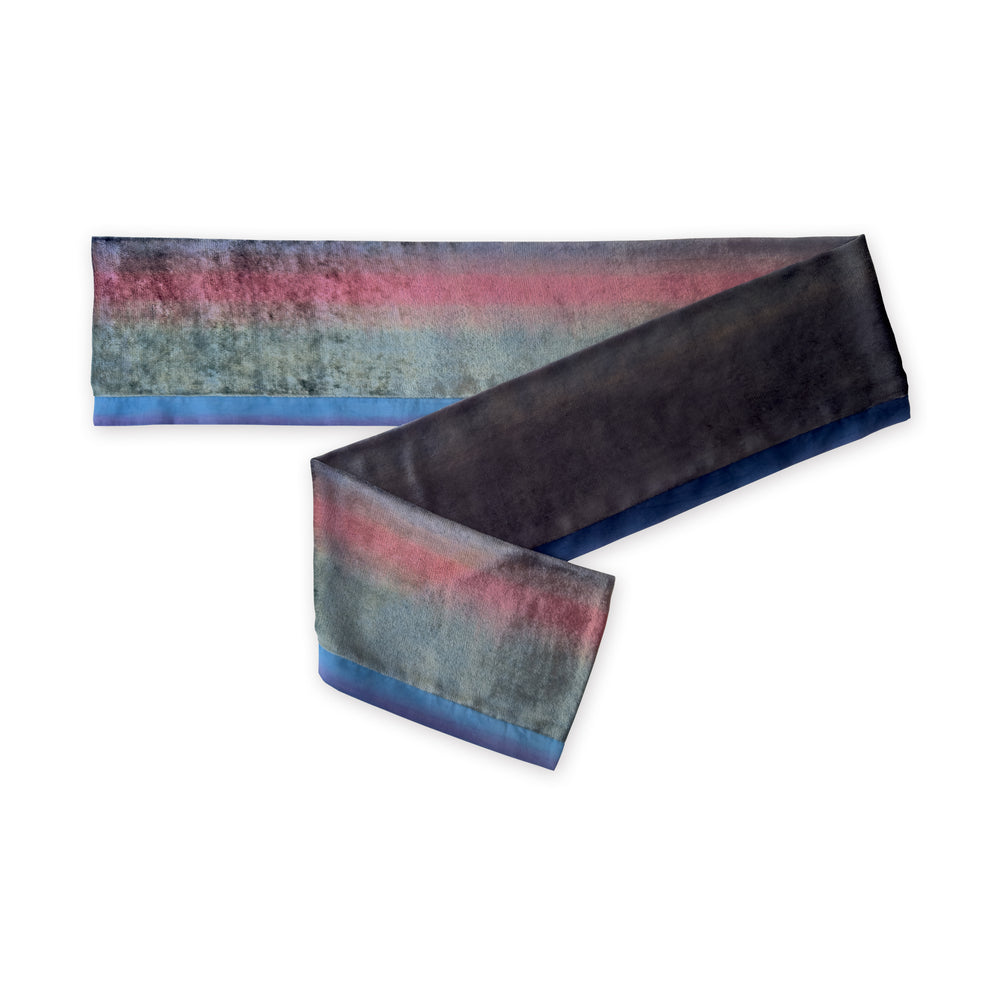Colorful velvet scarf in green, pink and blue navy shades on a white background. t is hand-painted scarf in measures 180 x 20 cm by otta-italy scarves brand. Luxury Italian velvet accessory, soft and warm scarf for women and men.
