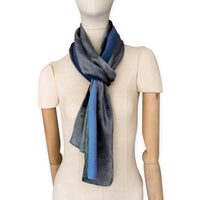 Mannequin wearing a colorful velvet scarf on a white background. Velvet scarf is in shades of green, pink and blue navy colors. It is hand-painted scarf in measures 180 x 20 cm by otta-italy scarves brand.
