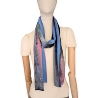 Mannequin wearing a colorful velvet scarf on a white background. Velvet scarf is in shades of green, pink and blue navy colors. It is hand-painted scarf in measures 180 x 20 cm by otta-italy scarves brand.
