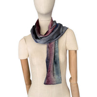 Mannequin wearing a colorful velvet scarf on a white background. Velvet scarf is in shades of green, pink and blue navy colors. It is hand-painted scarf in measures 180 x 20 cm by otta-italy scarves brand.
