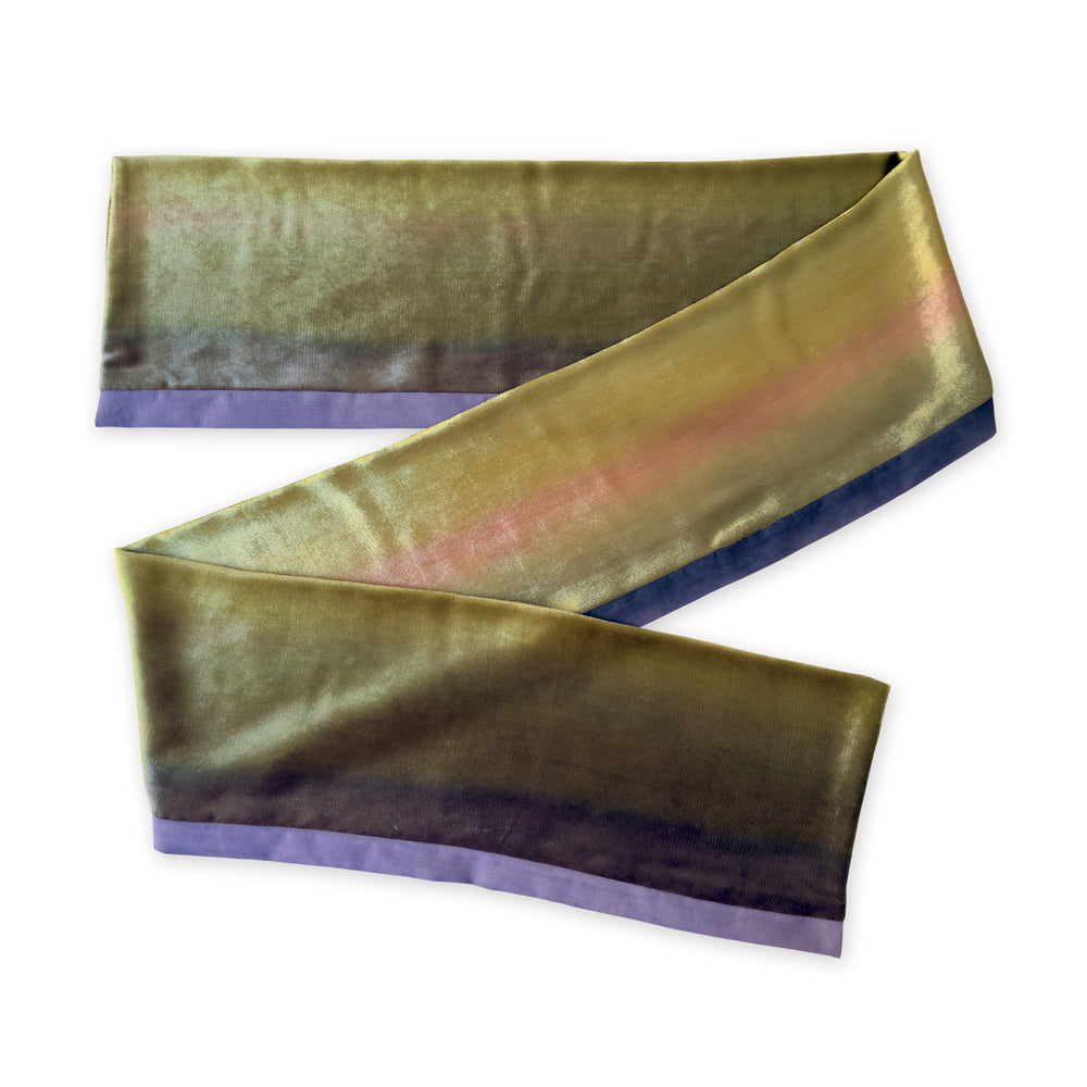 Colorful velvet scarf in green, pink and purple shades on a white background. t is hand-painted scarf in measures 185 x 20 cm by otta-italy scarves brand. Luxury Italian velvet accessory, soft and warm scarf for women and men.
