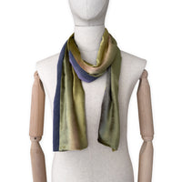 Mannequin wearing a colorful velvet scarf on a white background. Velvet scarf is in shades of green, pink and purple colors. It is hand-painted scarf in measures 185 x 20 cm by otta-italy scarves brand.
