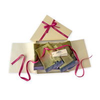 Set of scarves in a gift box with a pink ribbon on a white background. 
Hand-painted velvet scarf by Otta-Italy, 185 x 20 cm, featuring green, pink and purple colors. Luxury Italian velvet scarf, soft and warm scarf for women and men.
