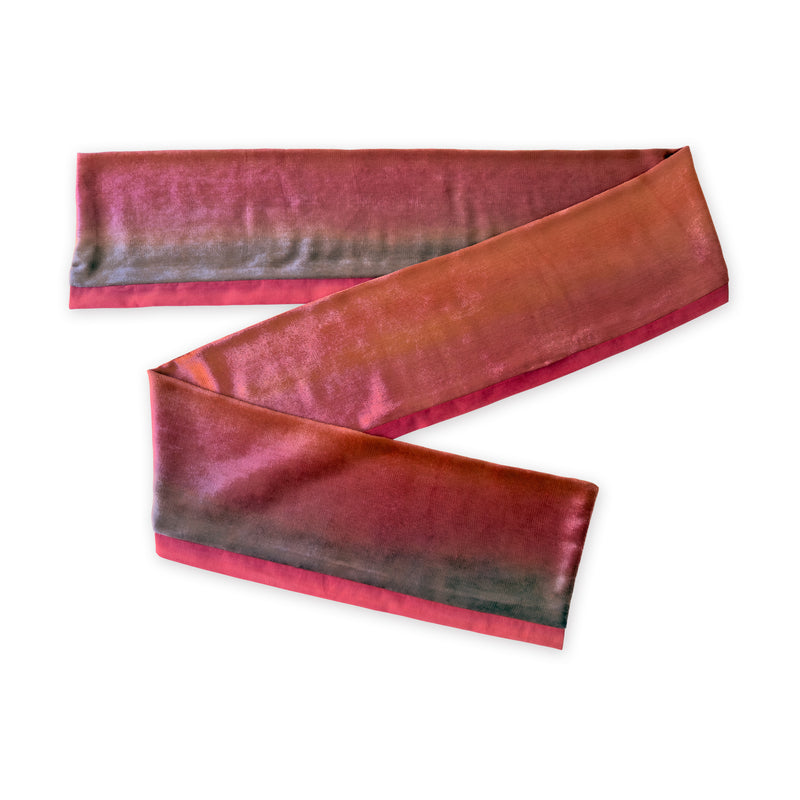 Colorful velvet scarf in red and purple shades on a white background. t is hand-painted scarf in measures 184 x 17 cm by otta-italy scarves brand. Luxury Italian velvet accessory, soft and warm scarf for women and men.
