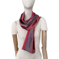 Mannequin wearing a colorful velvet scarf on a white background. Velvet scarf is in shades of red and purple colors. It is hand-painted scarf in measures 184 x 17 cm by otta-italy scarves brand.
