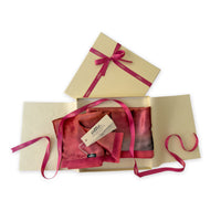 Set of scarves in a gift box with a pink ribbon on a white background. 
Hand-painted velvet scarf by Otta-Italy, 184 x 17 cm, featuring red and purple colors. Luxury Italian velvet scarf, soft and warm scarf for women and men.
