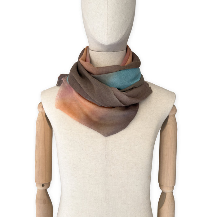 Mannequin wearing scarf on a white background. Hand-painted wool scarf by Otta-Italy, 56 x 177 cm, featuring brown, turquoise, peach colors. Luxury Italian accessory, soft and warm scarf for women and men.
