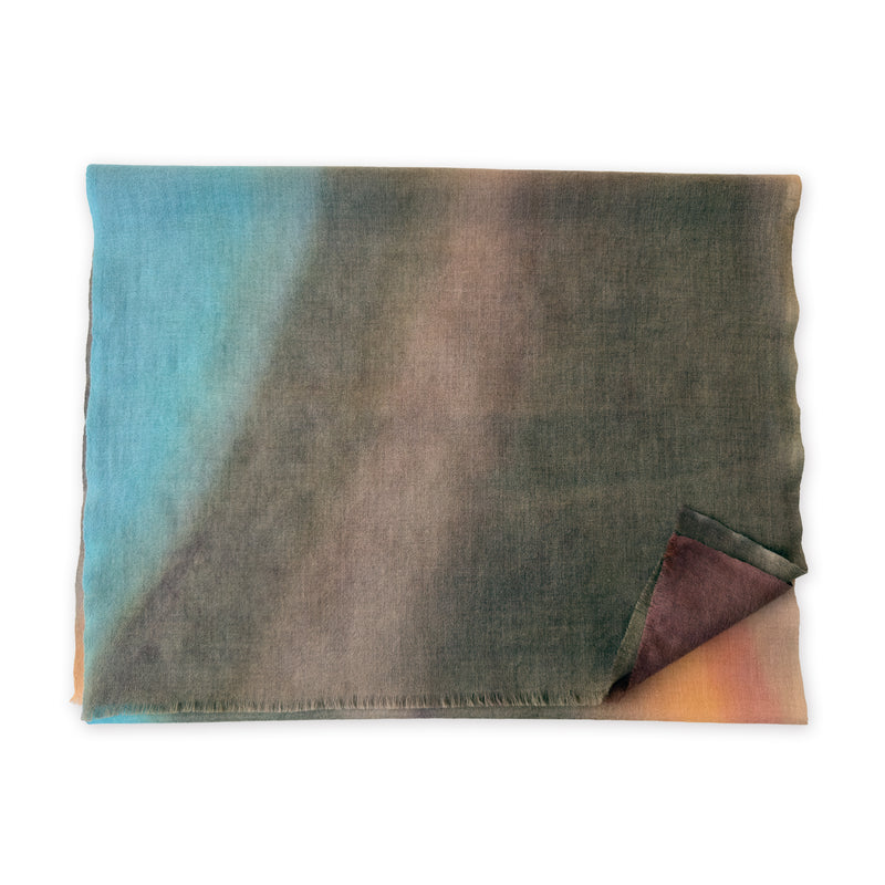 Colorful wool scarf in brown, turquoise, peach shades on a white background. It is hand-painted scarf in measures 56 x 177 cm by otta-italy scarves brand. Luxury Italian accessory, soft and warm scarf for women and men.
