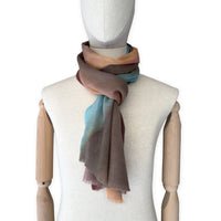 Mannequin wearing scarf on a white background. Hand-painted wool scarf by Otta-Italy, 56 x 177 cm, featuring brown, turquoise, peach colors. Luxury Italian accessory, soft and warm scarf for women and men.
