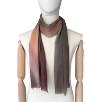 Mannequin wearing scarf on a white background. Hand-painted wool scarf by Otta-Italy, 56 x 177 cm, featuring brown, turquoise, peach colors. Luxury Italian accessory, soft and warm scarf for women and men.
