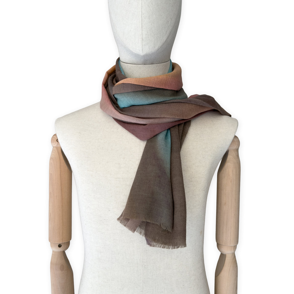 Mannequin wearing scarf on a white background. Hand-painted wool scarf by Otta-Italy, 56 x 177 cm, featuring brown, turquoise, peach colors. Luxury Italian accessory, soft and warm scarf for women and men.
