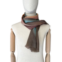 Mannequin wearing scarf on a white background. Hand-painted wool scarf by Otta-Italy, 56 x 177 cm, featuring brown, turquoise, peach colors. Luxury Italian accessory, soft and warm scarf for women and men.
