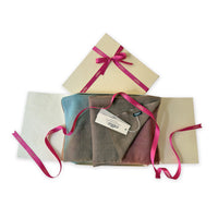 Set of scarves in a gift box with a pink ribbon on a white background. 
Hand-painted wool scarf by Otta-Italy, 56 x 177 cm, featuring brown, turquoise, peach colors. Luxury Italian accessory, soft and warm scarf for women and men.
